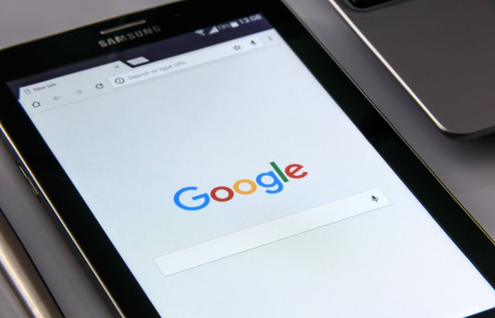 Close-up of a tablet displaying Google's search screen, emphasizing technology and internet browsing.
